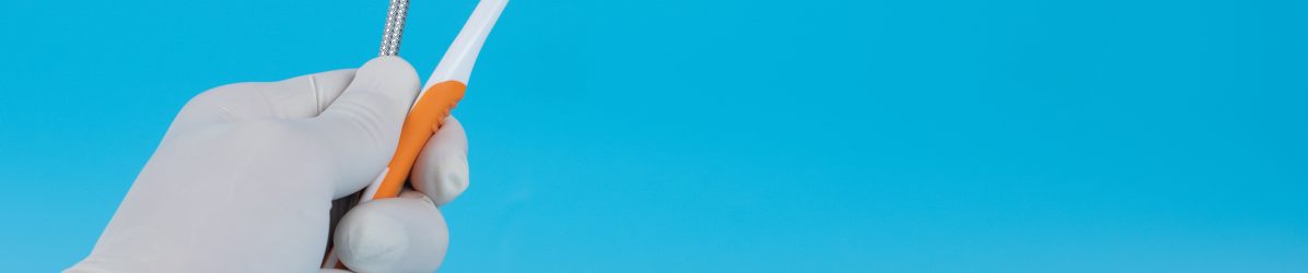 The dentist holds a mounted mirror to show the patient's dental examination.